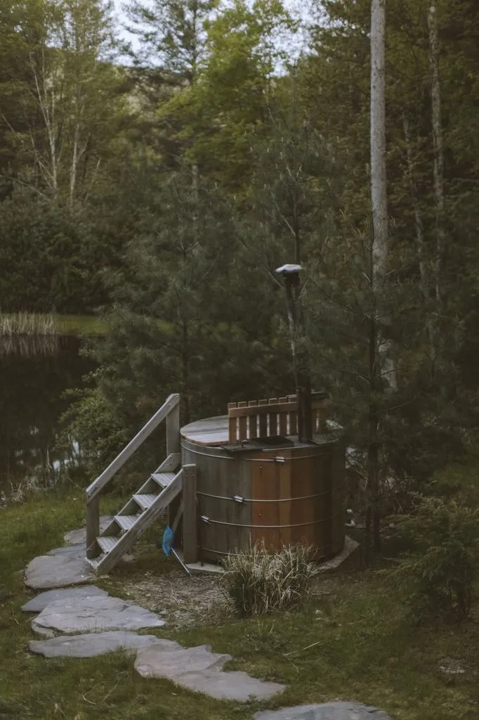 Cedar wood-fired hot tub by the pond