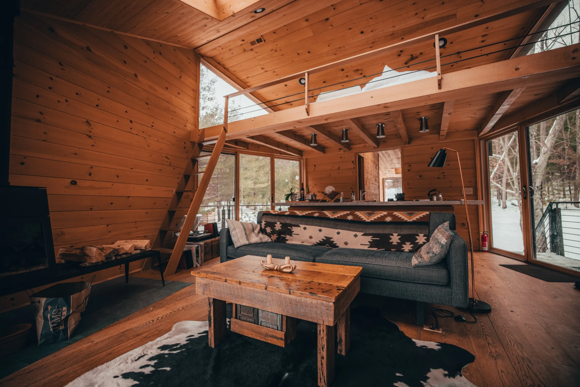Wide view of living area with loft above